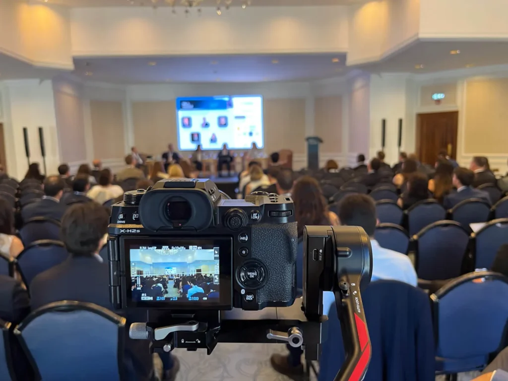 Filming a conference speaker on stage for corporate video coverage in Istanbul