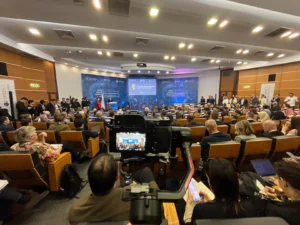 Wide-angle video coverage of a conference speaker on stage in Istanbul